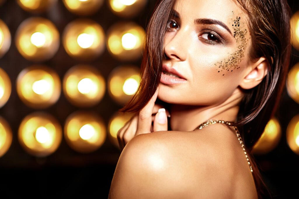 beautiful girl model in summer colorful dress with bright creative makeup on black studio lights background