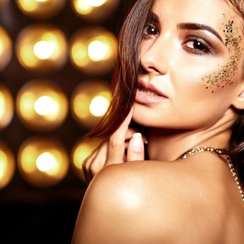 beautiful girl model in summer colorful dress with bright creative makeup on black studio lights background